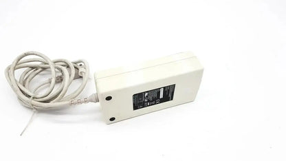 Off-white spacelabs snp-a085-3y rectangular power adapter with coiled beige cable and black label for medical equipment