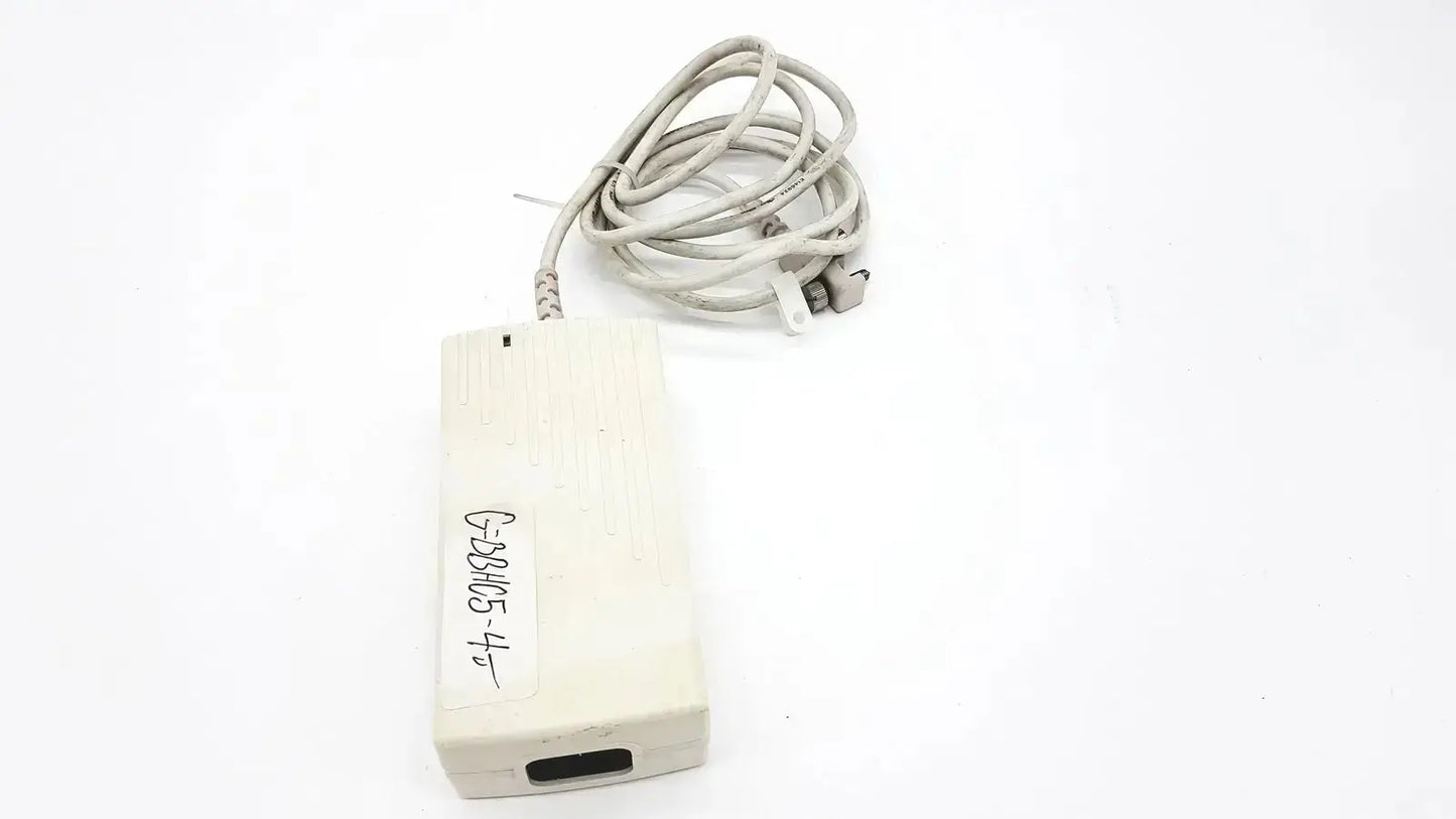 Off-white rectangular spacelabs snp-a085-3y power adapter with coiled gray cable and handwritten label for used medical equipment sale