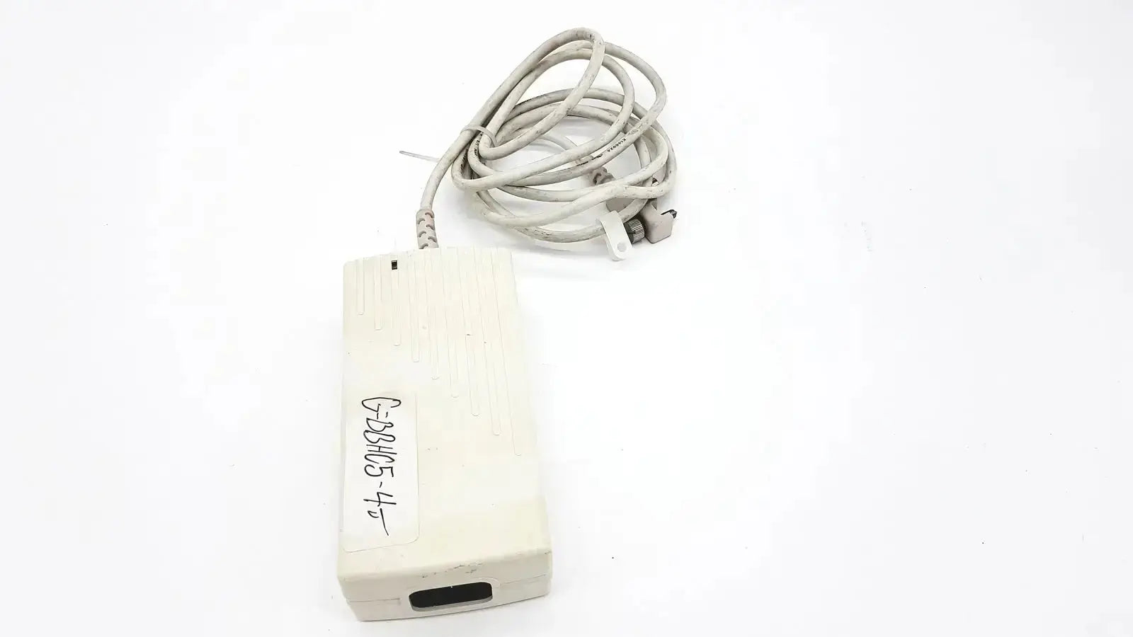 Off-white rectangular spacelabs snp-a085-3y power adapter with coiled gray cable and handwritten label for used medical equipment sale