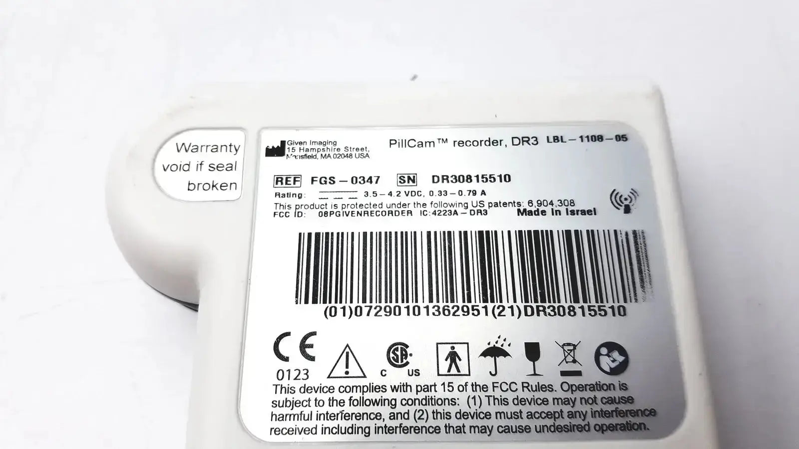 White plastic imaging pillcam recorder dr3 wireless capsule endoscopy device with rounded casing and regulatory labels