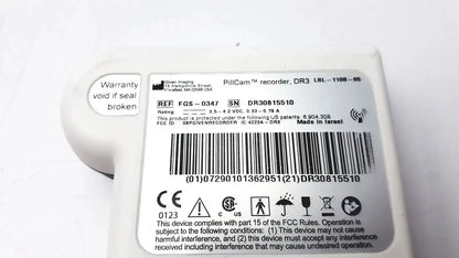 White plastic imaging pillcam recorder dr3 wireless capsule endoscopy device with rounded casing and regulatory labels