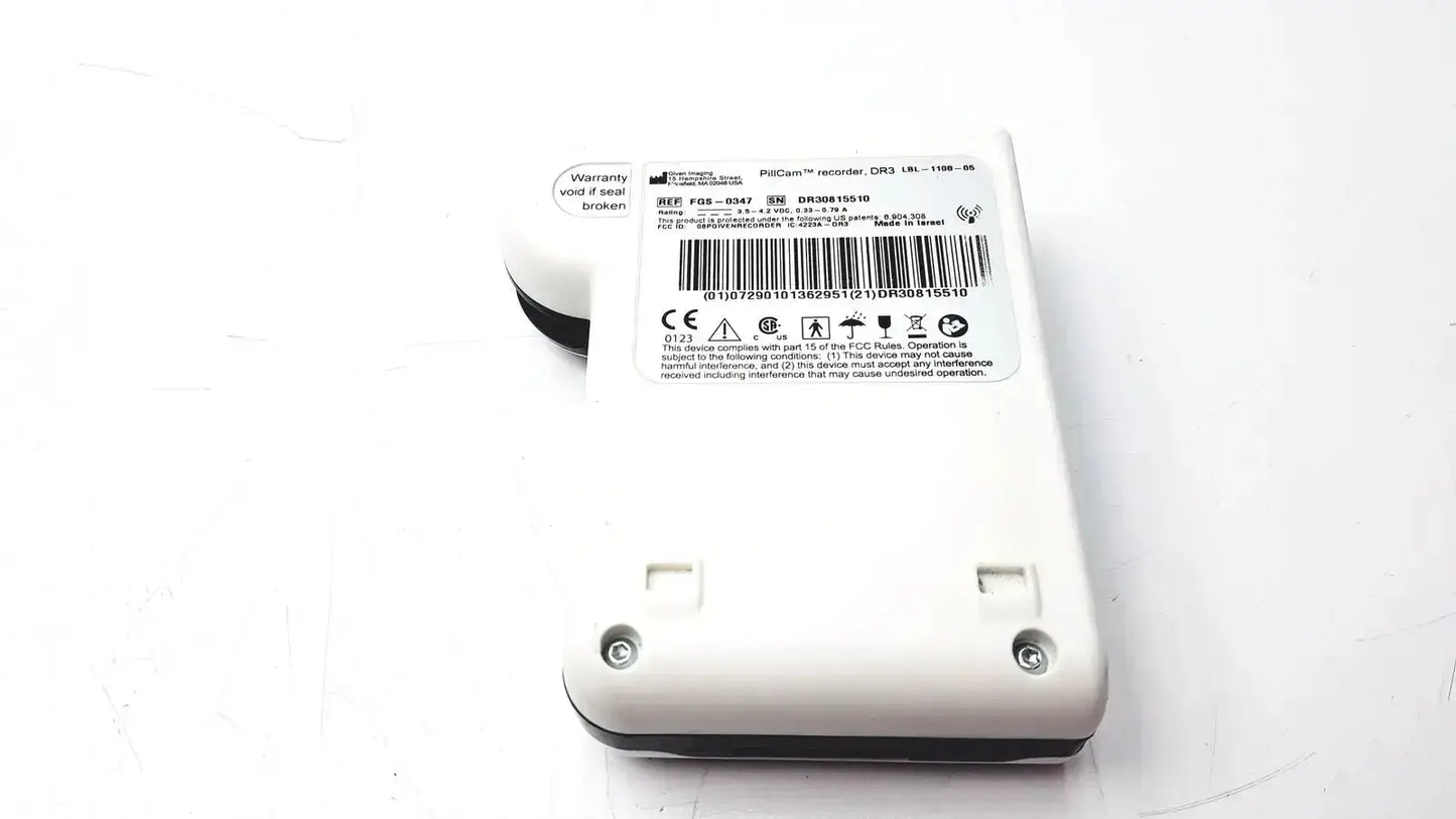 White plastic pinnacle imaging pillcam recorder dr3 with black accents and circular lens on top for medical use