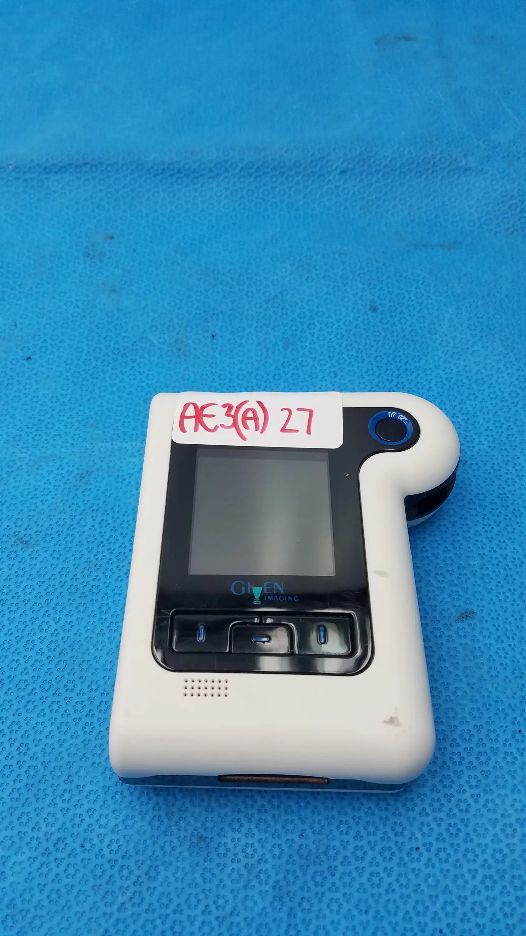 White plastic handheld glucose meter with small screen and black buttons by glycemix for buy used medical equipment