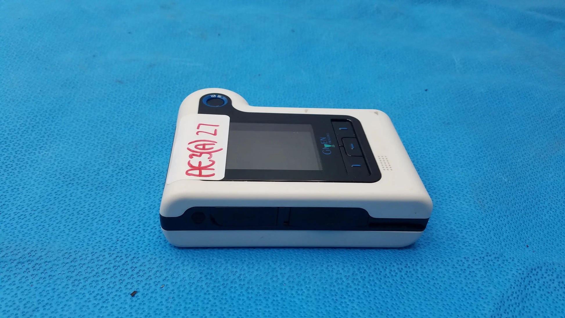 White and black handheld glucose meter with screen buttons and camera lens for buy used medical equipment sale