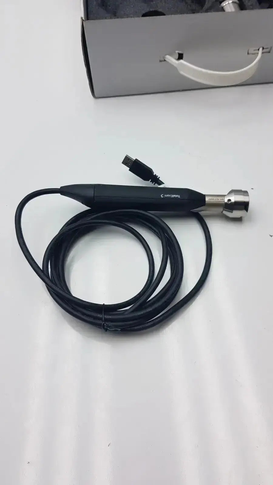 Black handheld endoscope with silver metallic tip and coiled cable from globalmed total exam ke018257 hd 1080p camera