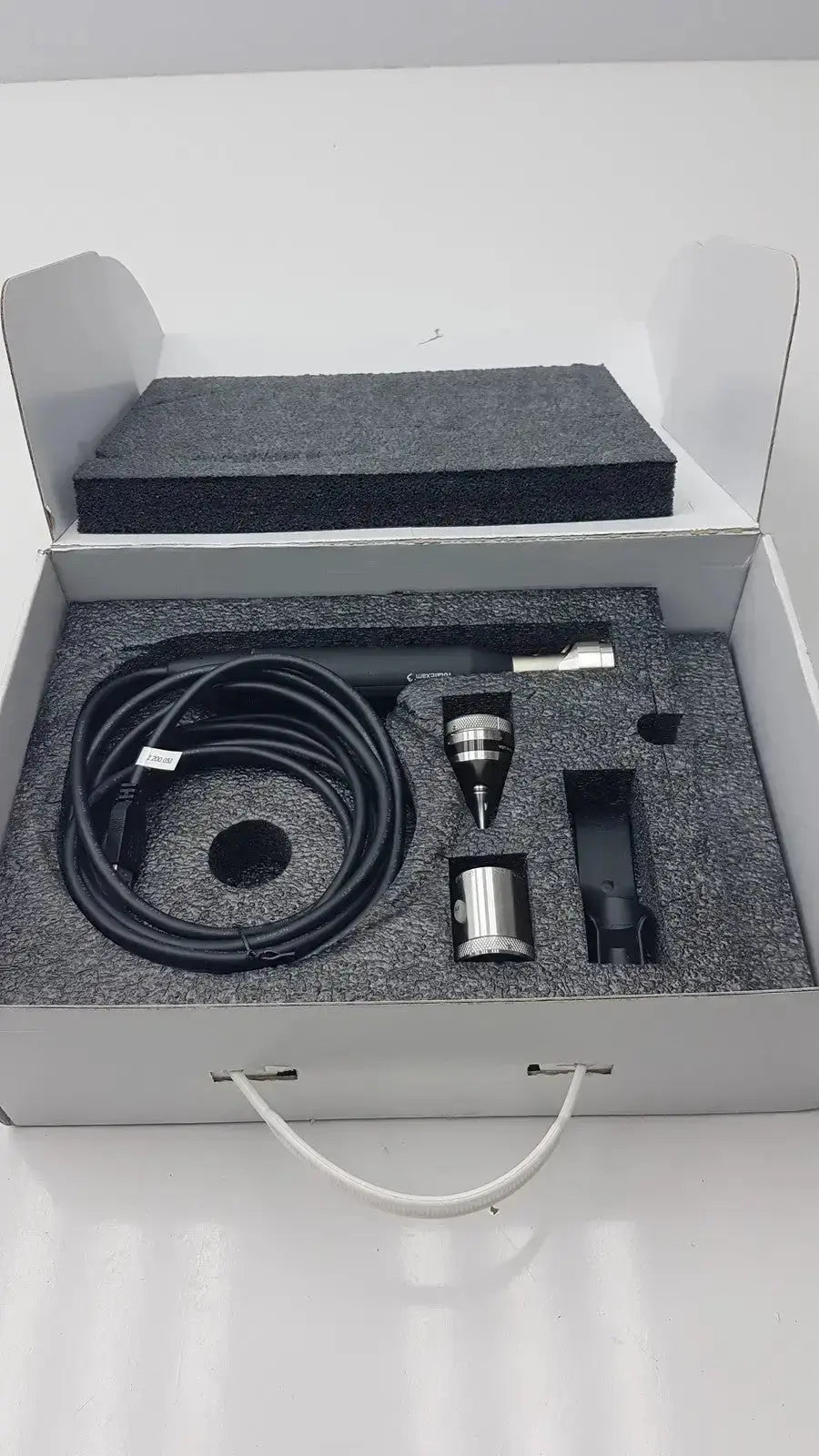Black coiled cable and metallic components in gray foam-lined box for globalmed total exam ke018257 hd 1080p camera