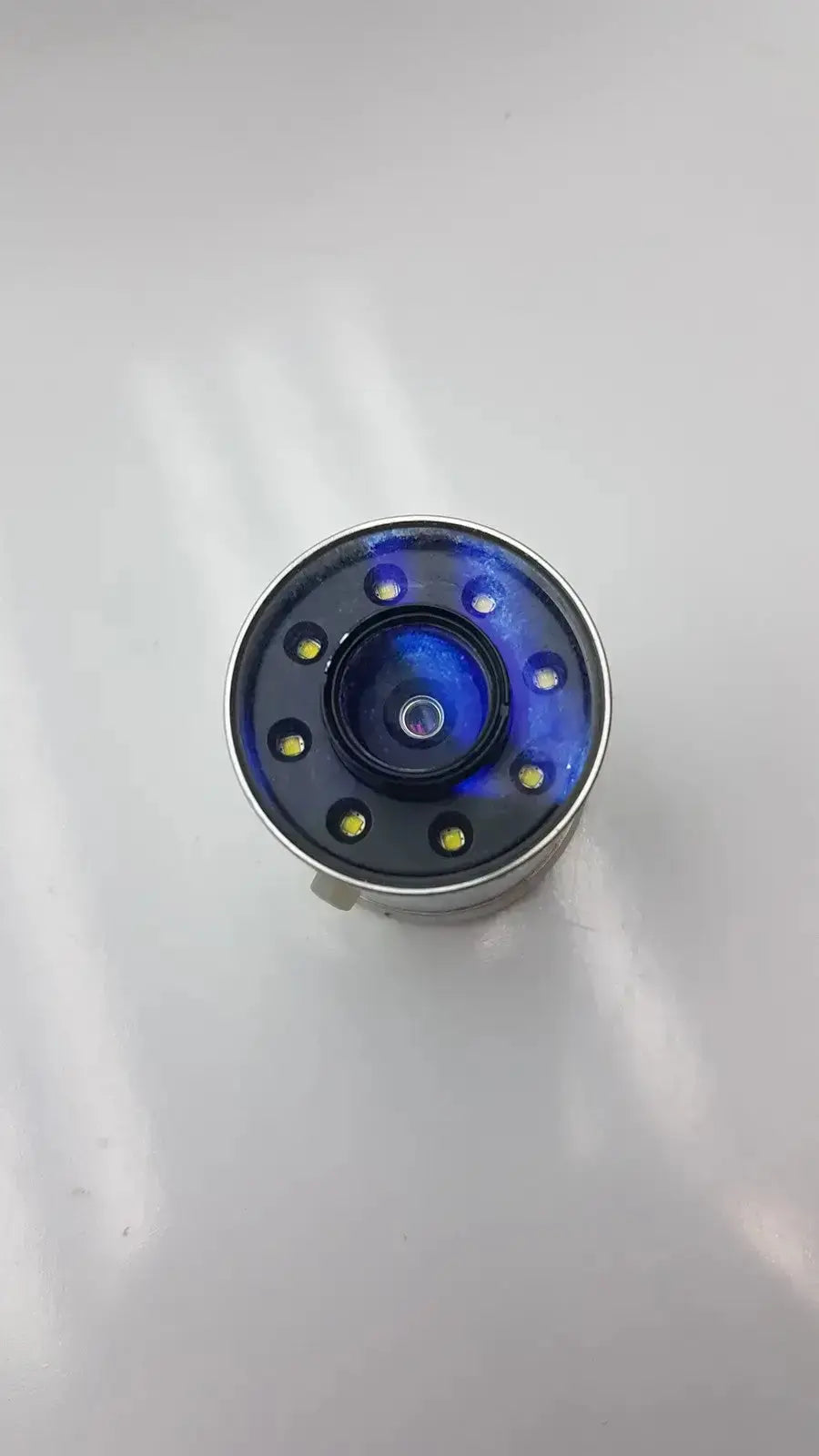 Circular blue led globalmed total exam ke018257 hd 1080p camera with metallic silver rim and eight yellow leds