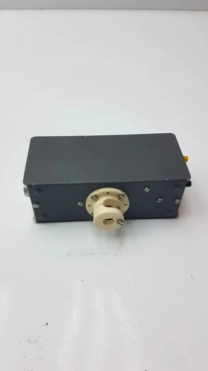 Black rectangular grass instrument amplifier model p17b with beige central component and silver screws shown from the back side