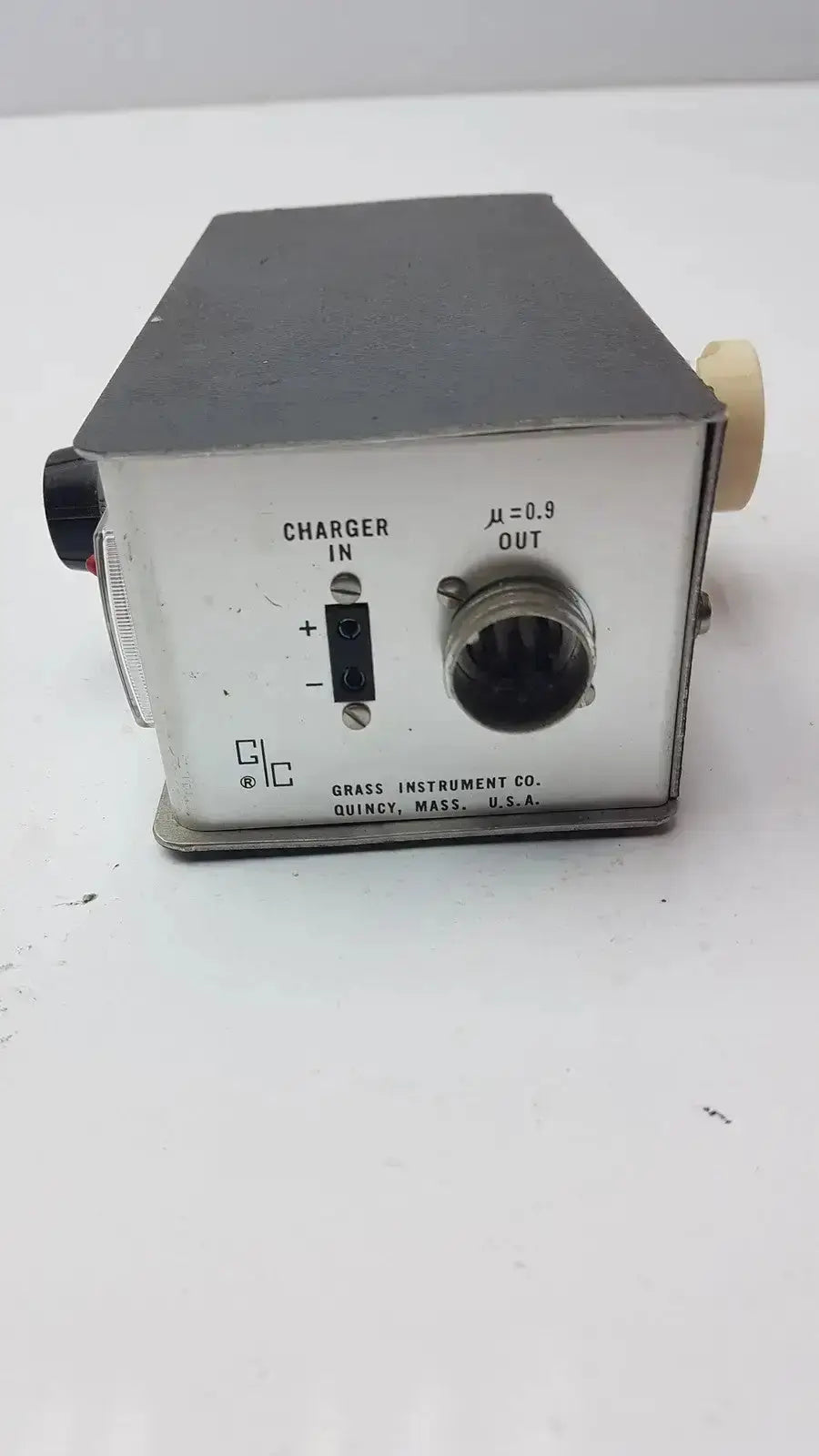 Silver metallic rectangular grass instrument amplifier model p17b back with black top and labeled ports including threaded output connector