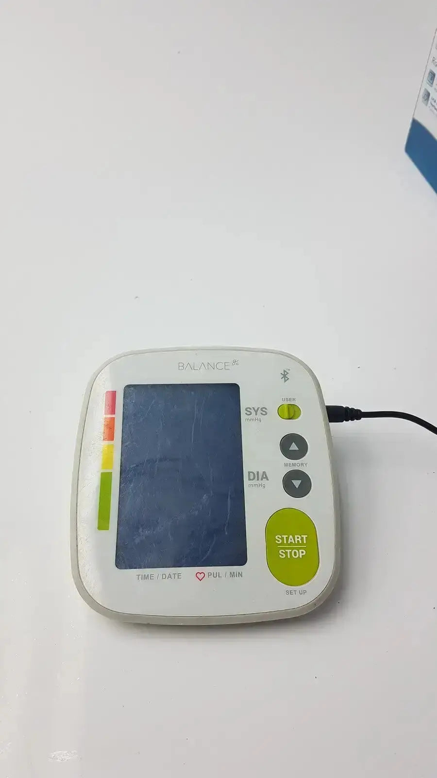 White and lime green Greater Goods 0604 bluetooth bpm blood pressure monitor with rectangular screen labeled balance