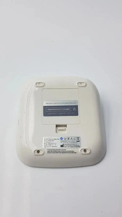 Off-white plastic wireless bluetooth bpm blood pressure router by greater goods with a rectangular product label on the back side