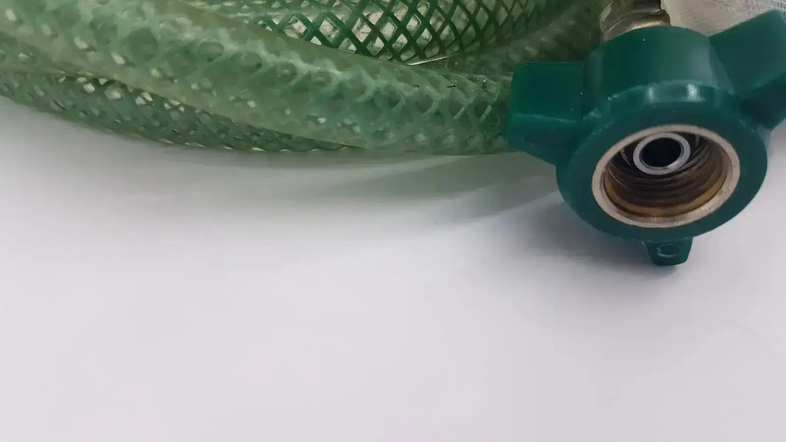 Green suction pump water hose with green mesh, teal plastic connector, and brass fitting for pump water use