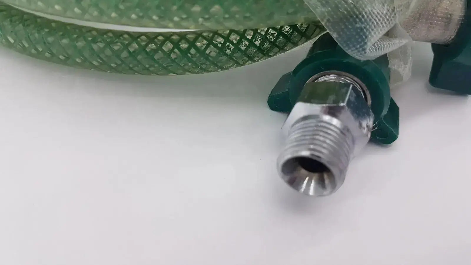 Green suction pump water hose with green mesh material and metallic threaded connector with dark green fittings
