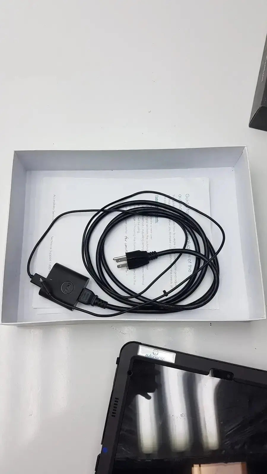 Black dell power adapter with coiled cable and plug for grid pad g-bbda2-10d used medical equipment for sale