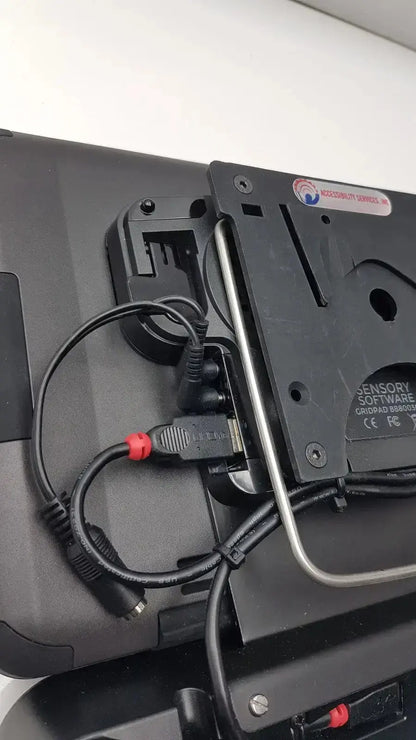 Black plastic mounting bracket with silver metal rod and red connector cables on back of grid pad g-bbda2-10d used medical equipment for sale