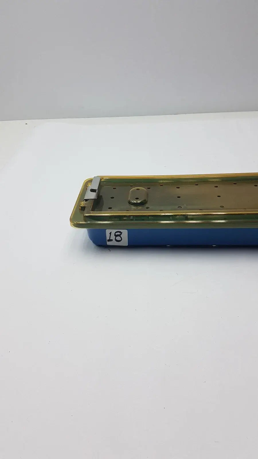 Gyrus MRA-GT slimline sterilization tray with blue plastic base and gold perforated metal lid for reuse medical equipment
