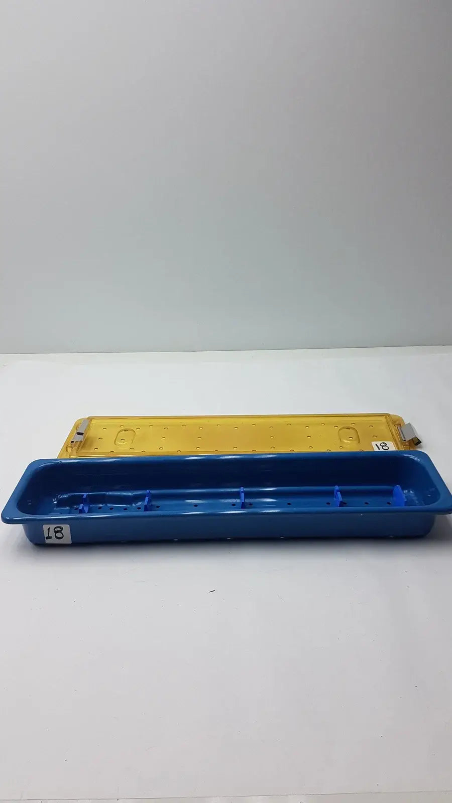 Blue plastic gyrus mra-gt slimline sterilization tray with yellow counterpart for reuse medical equipment
