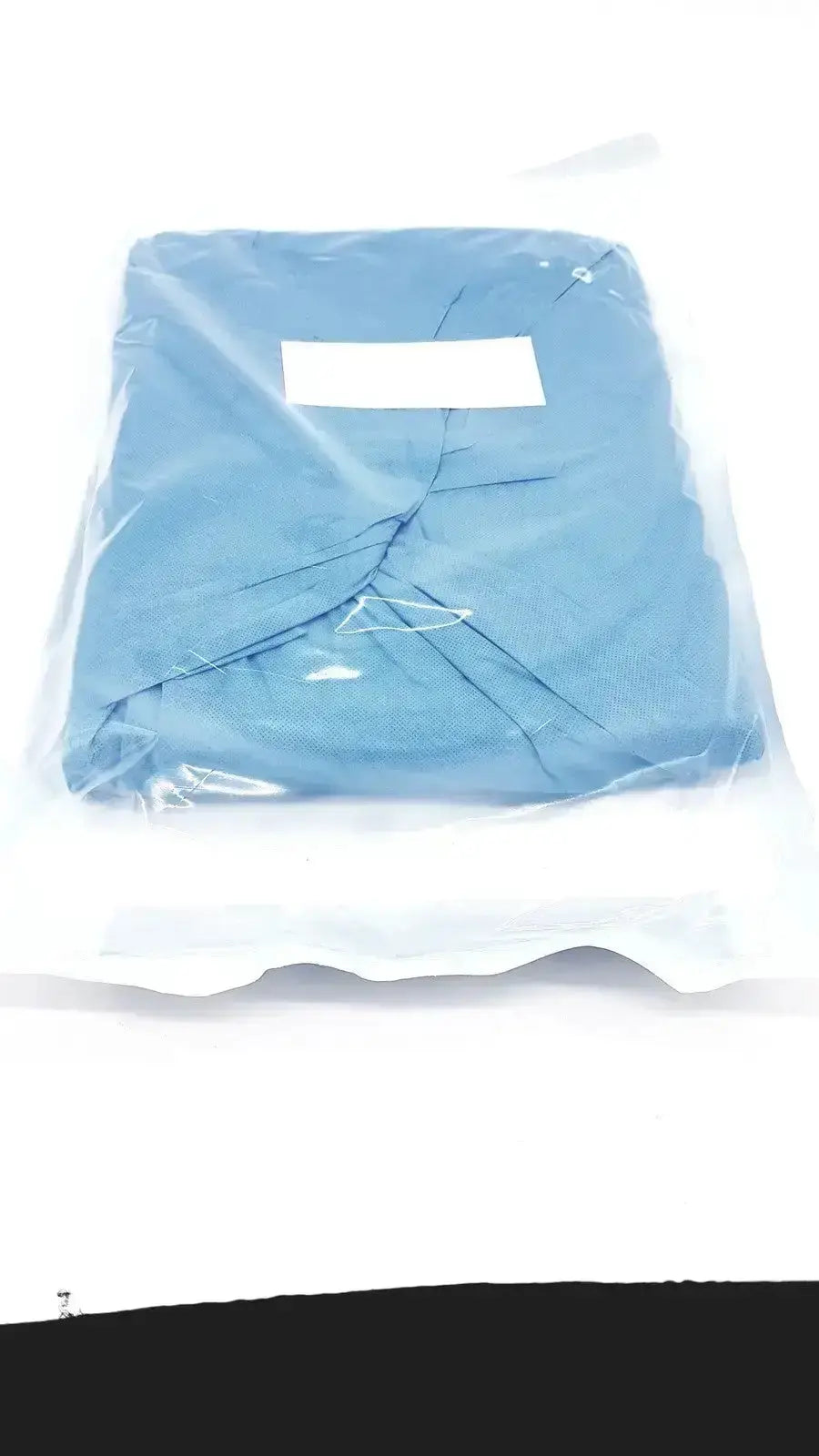 Blue medical scrub top sealed in a clear vacuum bag alongside halyard 89274 orthoarts shoulder split drape general drapes