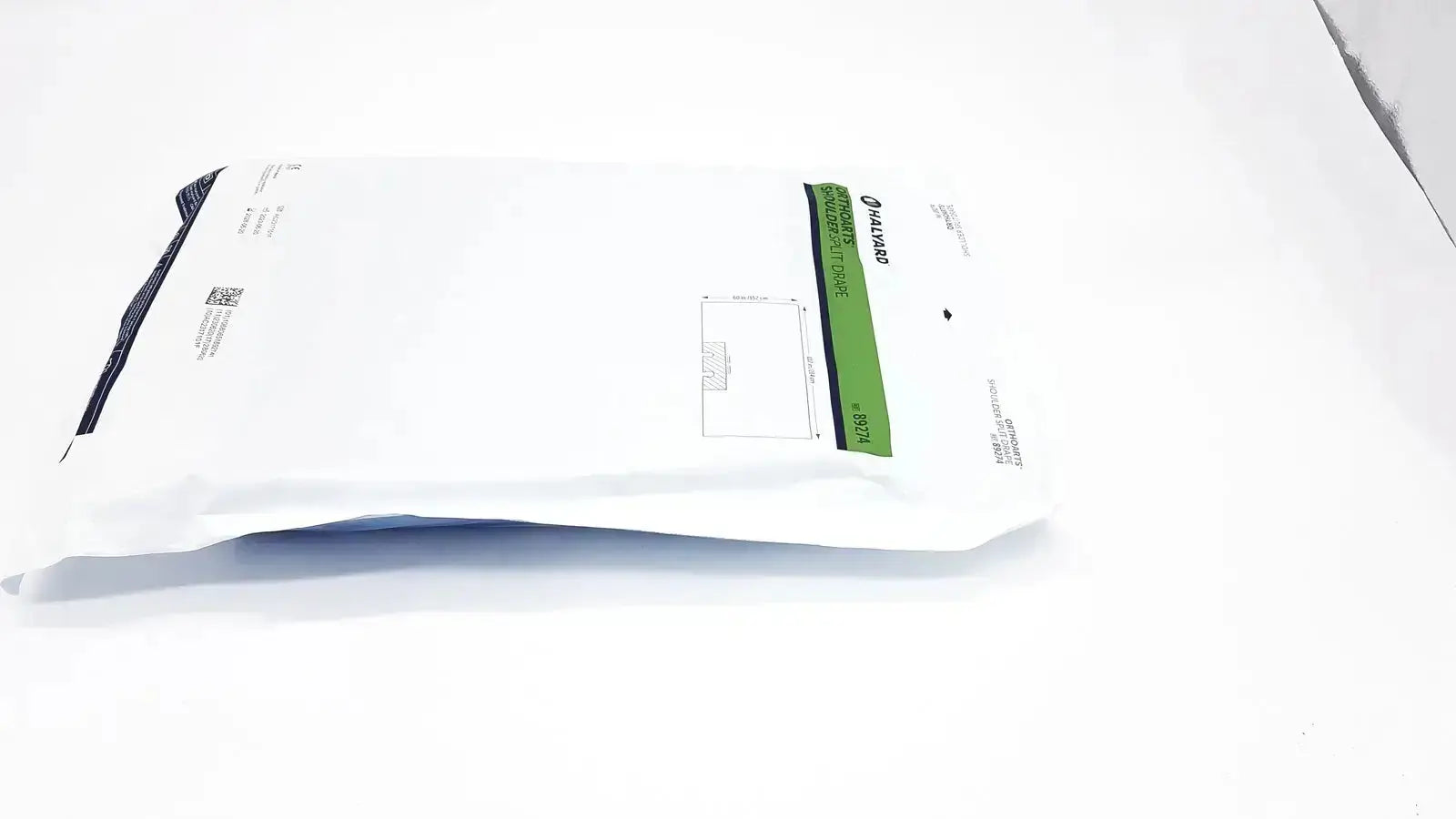 White plastic mailer with green and black packaging label containing halyard 89274 orthoarts shoulder split drape for general drapes and pre owned medical equipment sale