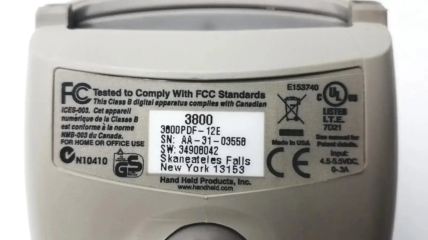 Beige plastic hand held products barcode scanner model 3800 with serial numbers and regulatory compliance markings