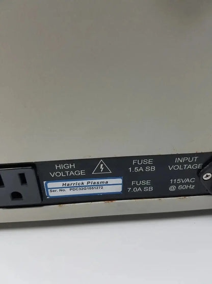 Black rectangular label with white text and blue-bordered harrick plasma sticker on the back of a plasma cleaner sterilizer unit