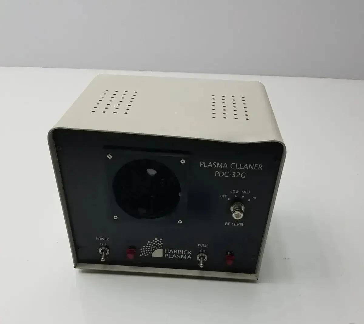 Beige harrick plasma pdc-32c plasma cleaner sterilizer with black front panel and control knobs for table-top use