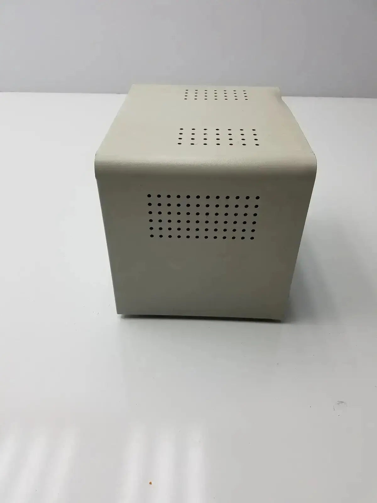 Beige rectangular metal enclosure with perforated ventilation panels of the harrick pdc-32g compact plasma cleaner sterilizer