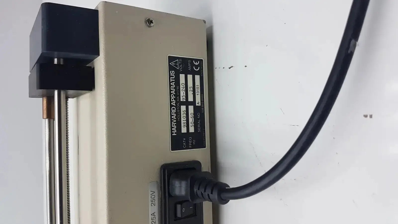 Beige Harvard Apparatus Model 11 digital single syringe pump with black power cord and metallic rod for precise dosing
