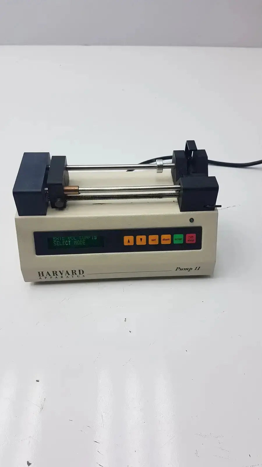 Beige harvard apparatus model 11 digital single syringe pump with black end caps and multicolor digital display buttons