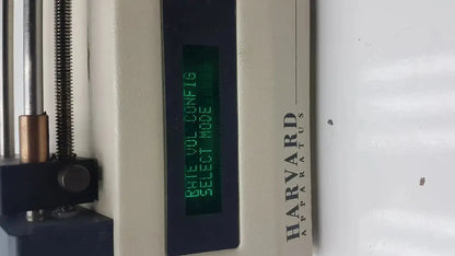 Harvard apparatus model 11 digital single syringe pump with metallic components and green lcd screen displaying rate vol config select mode