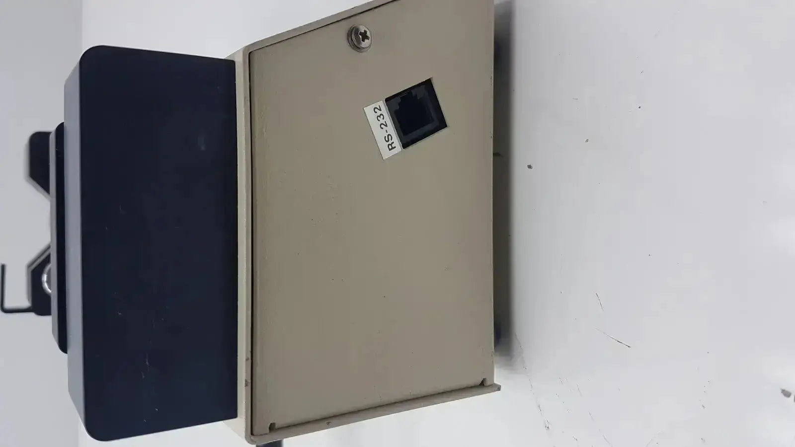 Beige metal enclosure of harvard apparatus model 11 digital single syringe pump with black rs-232 ethernet port and silver screw top