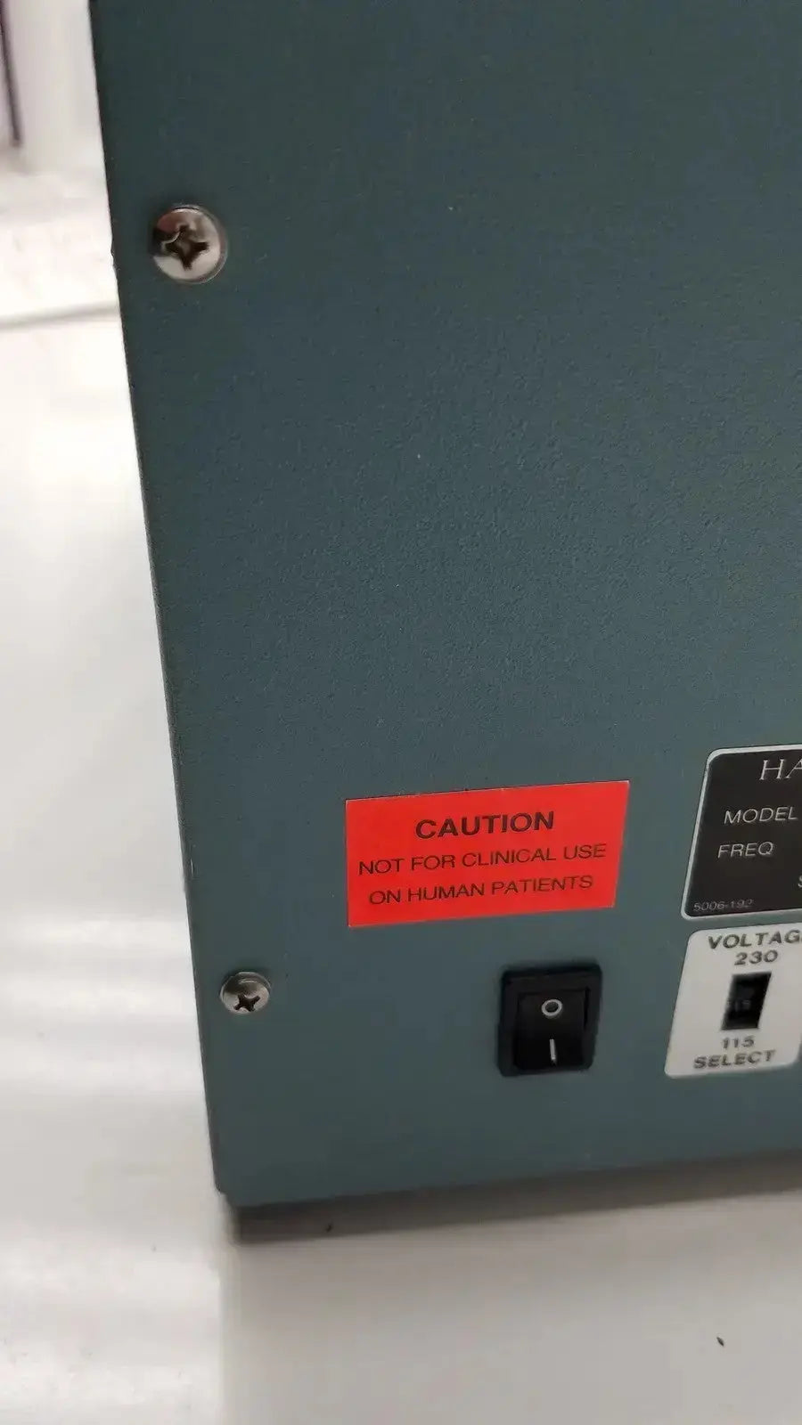 Gray metal industrial control panel with black power switch and red caution label on harvard apparatus rodent ventilator model 683