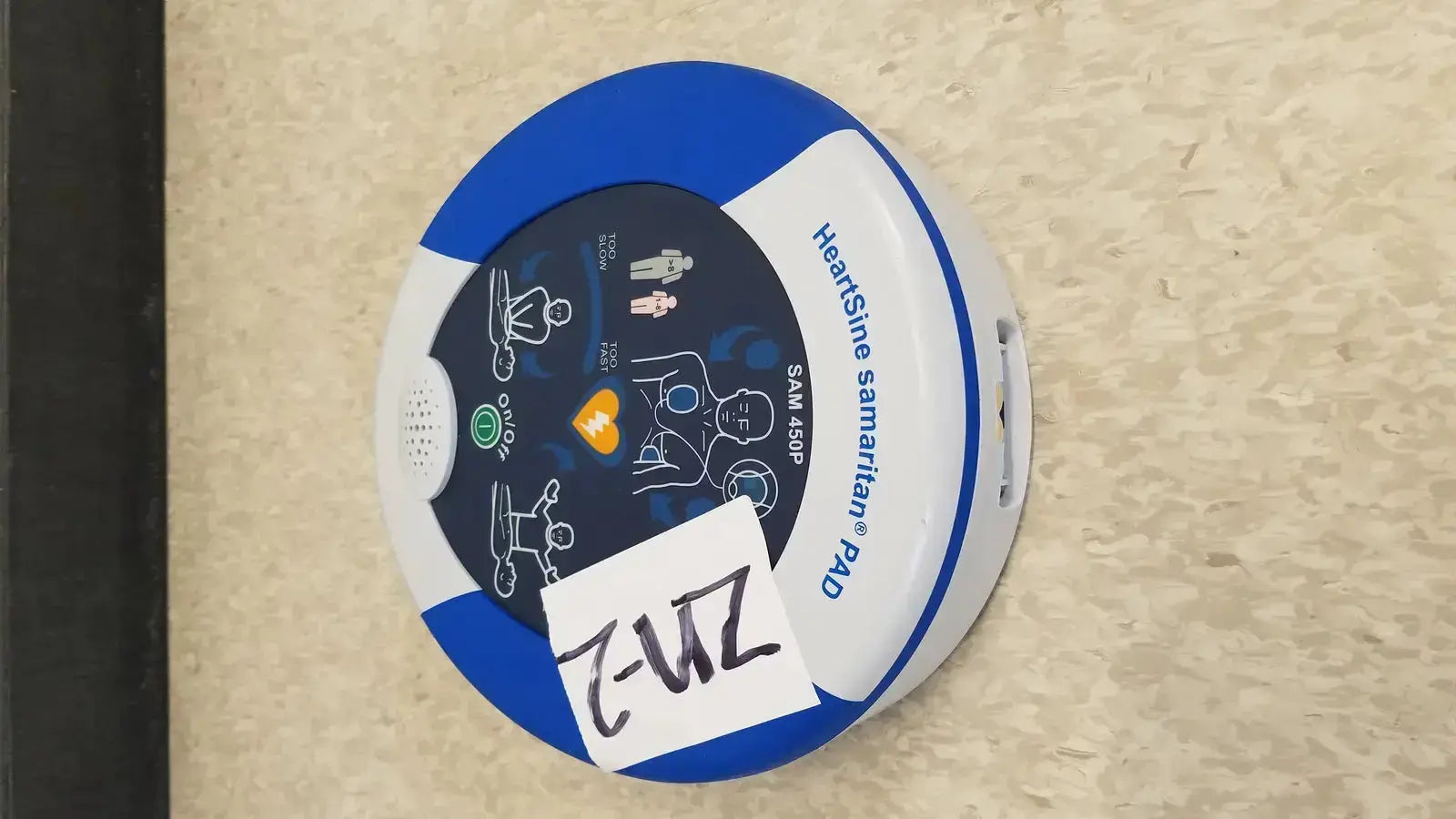 Blue and white circular heartsine samaritan pad 450p with instructional diagrams for easy use in emergencies