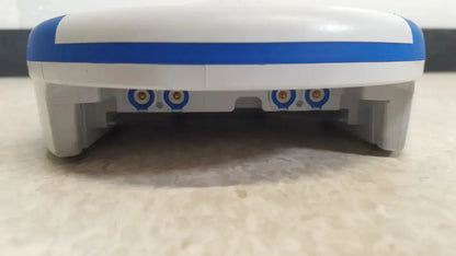 White and blue plastic robot vacuum cleaner with circular sensor lights underside shown with heartsine samaritan pad 450p