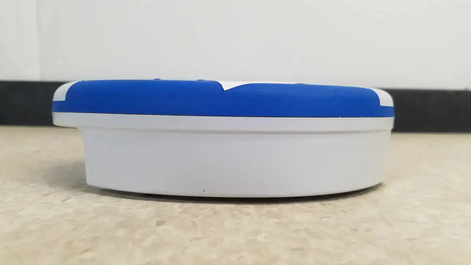Blue and white plastic ashtray with rounded oval shape for heartsine samaritan pad 450p emergency use