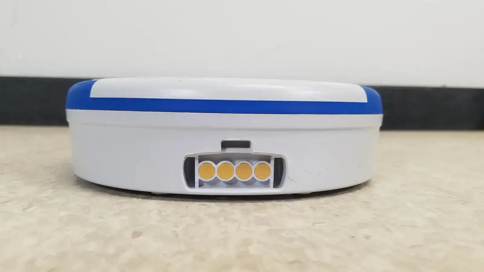 White and blue robotic vacuum cleaner with circular base and four yellow indicator lights for heartsine samaritan pad 450p