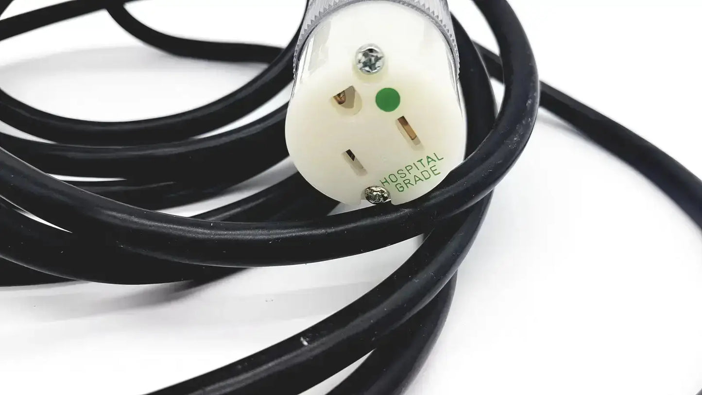 Black coiled heavy-duty extension cord with white hospital grade lead single phase plug and green grounding indicator