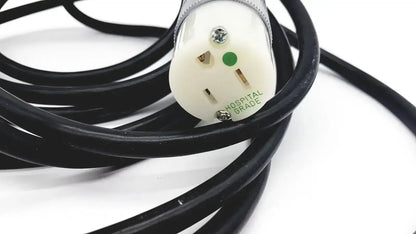Black coiled heavy-duty extension cord with white hospital grade lead single phase plug and green grounding indicator