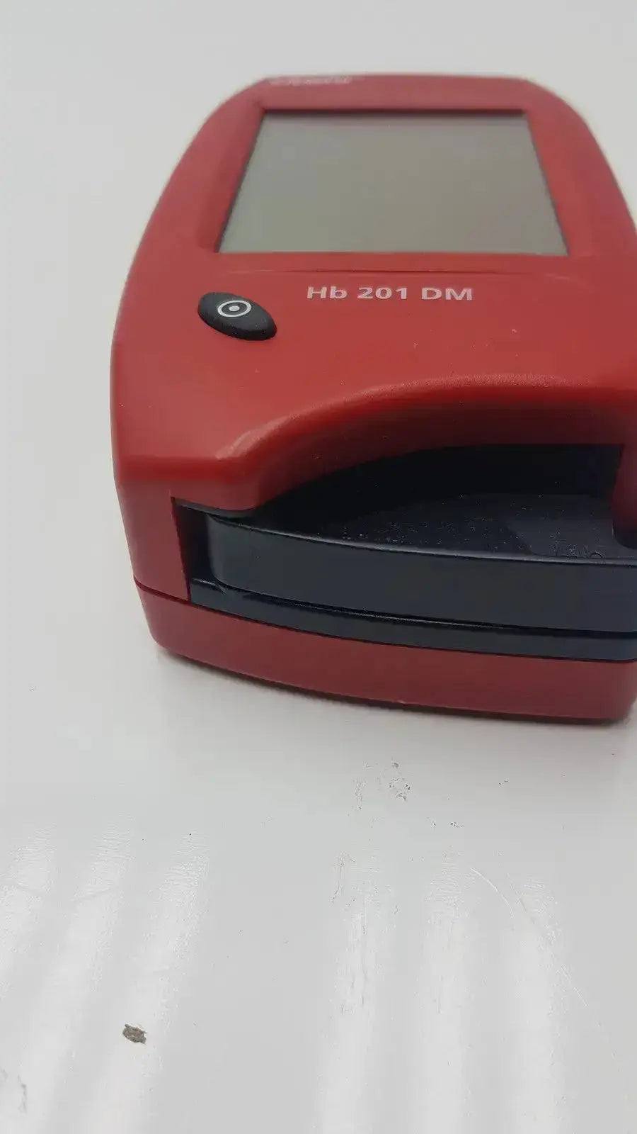 Red Hb 201 dm handheld barcode scanner with small screen and black button for biomedical evaluation and hospital surplus reuse medical