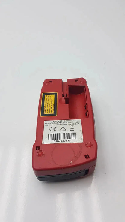 Red plastic hemocue hb 201-59 hemoglobin system analyzer with yellow warning label for biomedical evaluation reuse medical hospital surplus