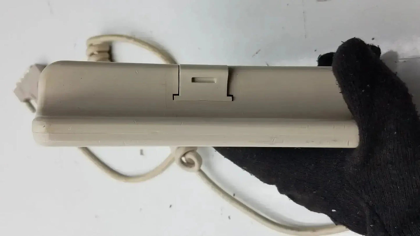 Beige plastic Hill-Rom patient hand control with coiled cord and switch for bed model 16646202