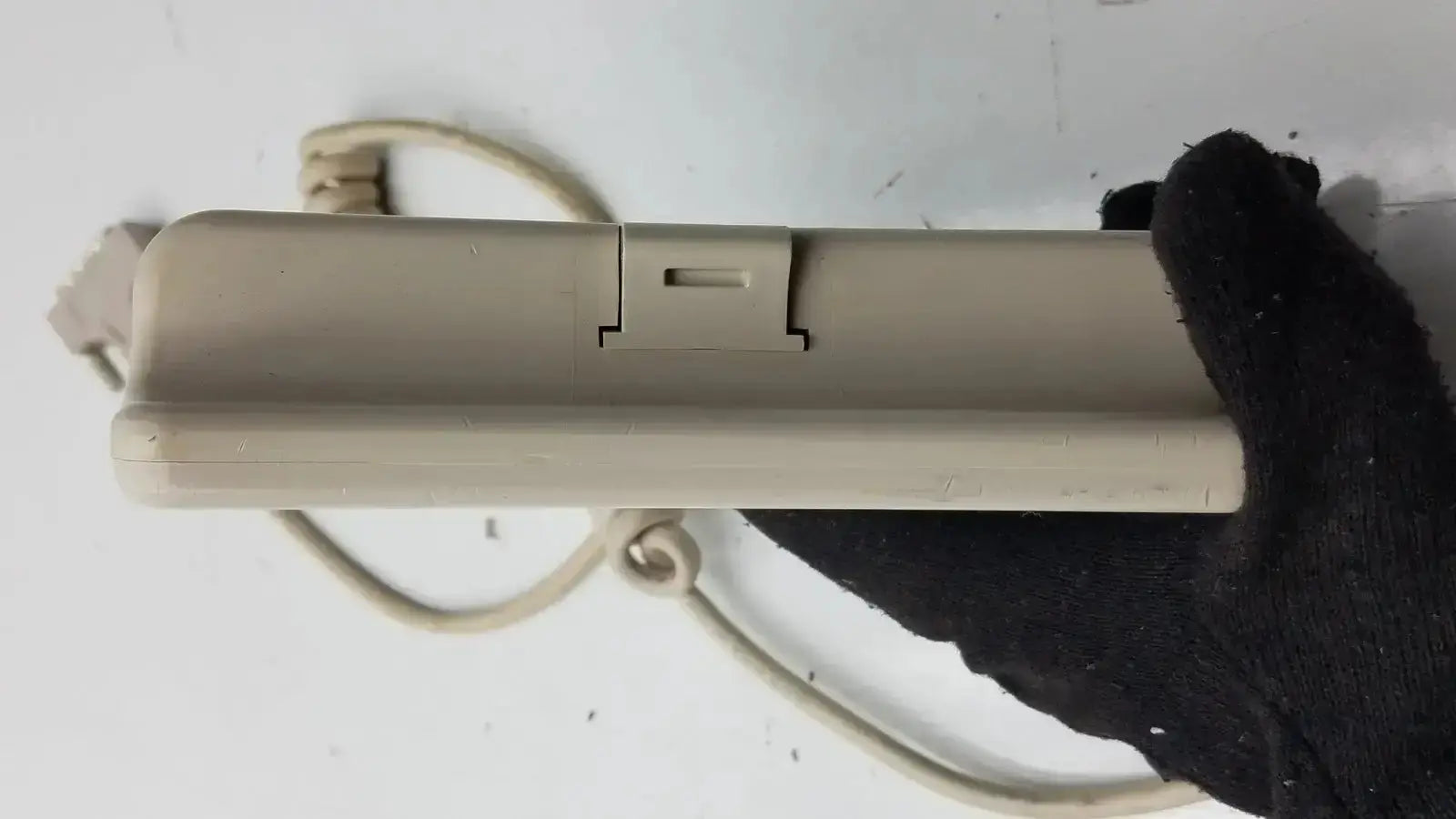Beige plastic Hill-Rom patient hand control with coiled cord and switch for bed model 16646202