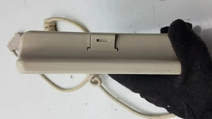 Beige plastic Hill-Rom patient hand control with coiled cord and switch for bed model 16646202