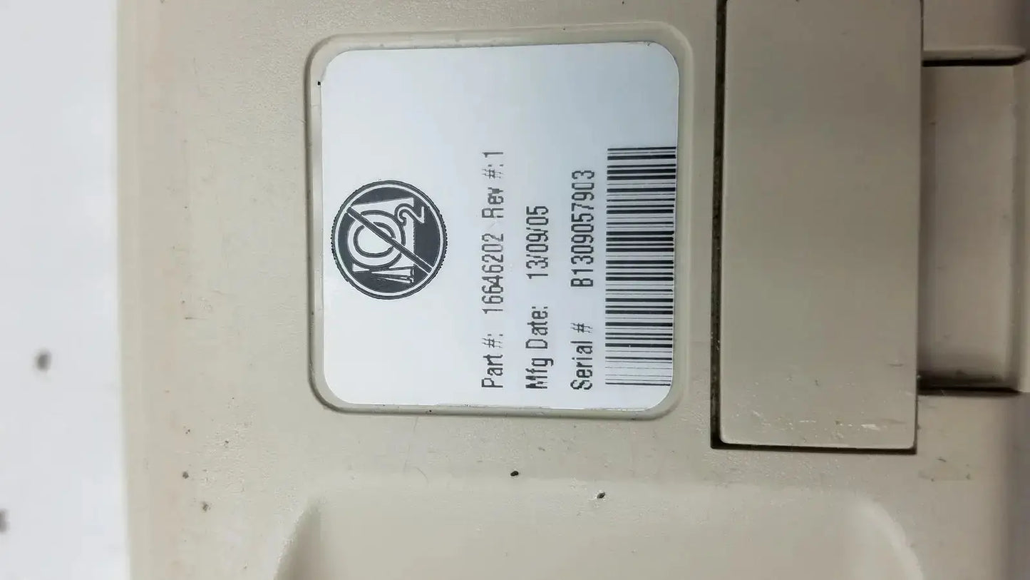 Beige plastic hill-rom patient hand control for bed with white label showing part number manufacturing date and serial number