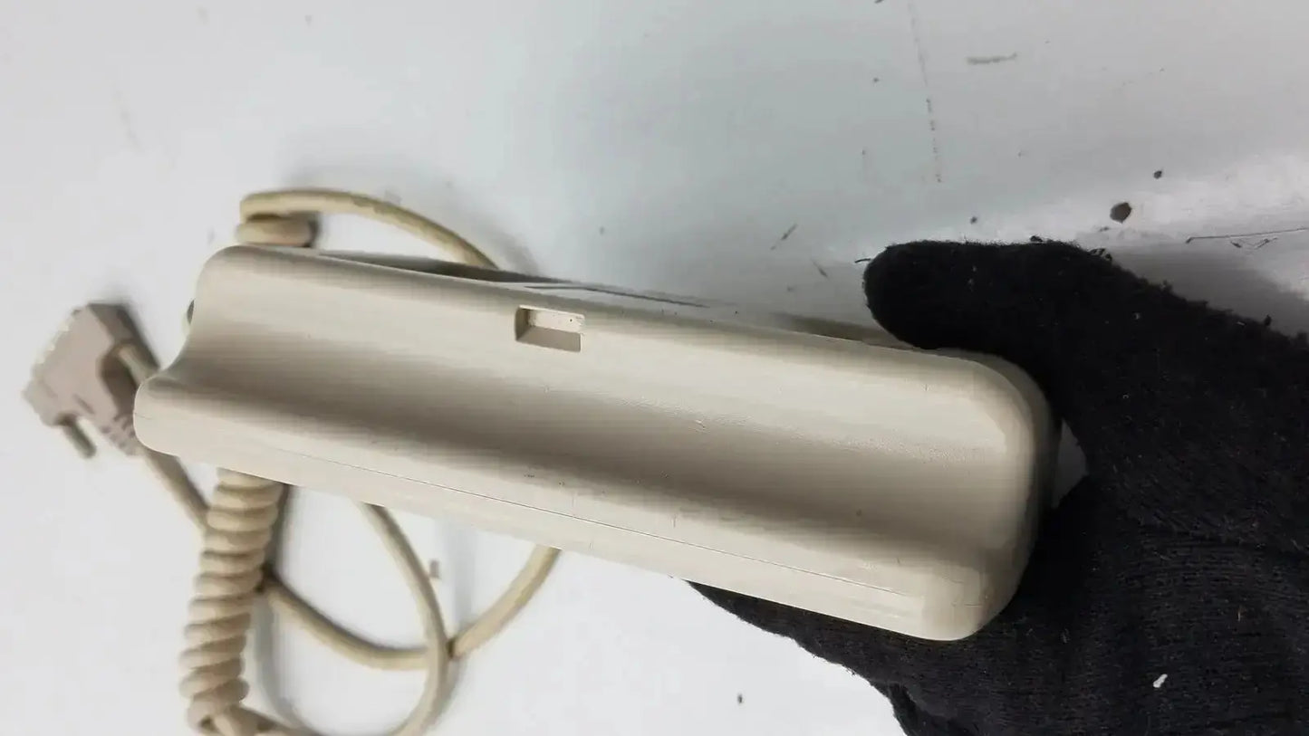 Beige plastic hill-rom patient hand control for bed 16646202 with coiled cord and plug for patient hand use