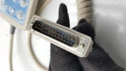 Gray plastic d-sub connector with metallic pins and screw on the back side of hill-rom patient hand control 16646202