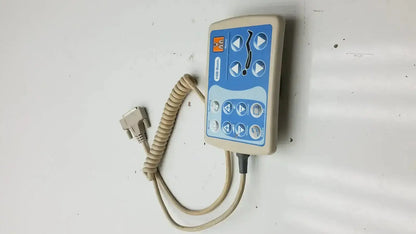 Beige and blue Hill-Rom patient hand control with coiled cable and d-sub connector for medical-grade bed use