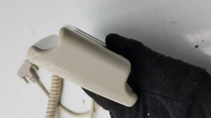 Beige plastic wall-mounted patient hand control with coiled cord for hill-rom patient bed 16646202