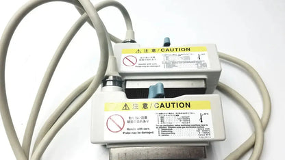 Gray medical probe connectors with caution labels and cables on the back side of hitachi eup-cc331 biplane transrectal probe