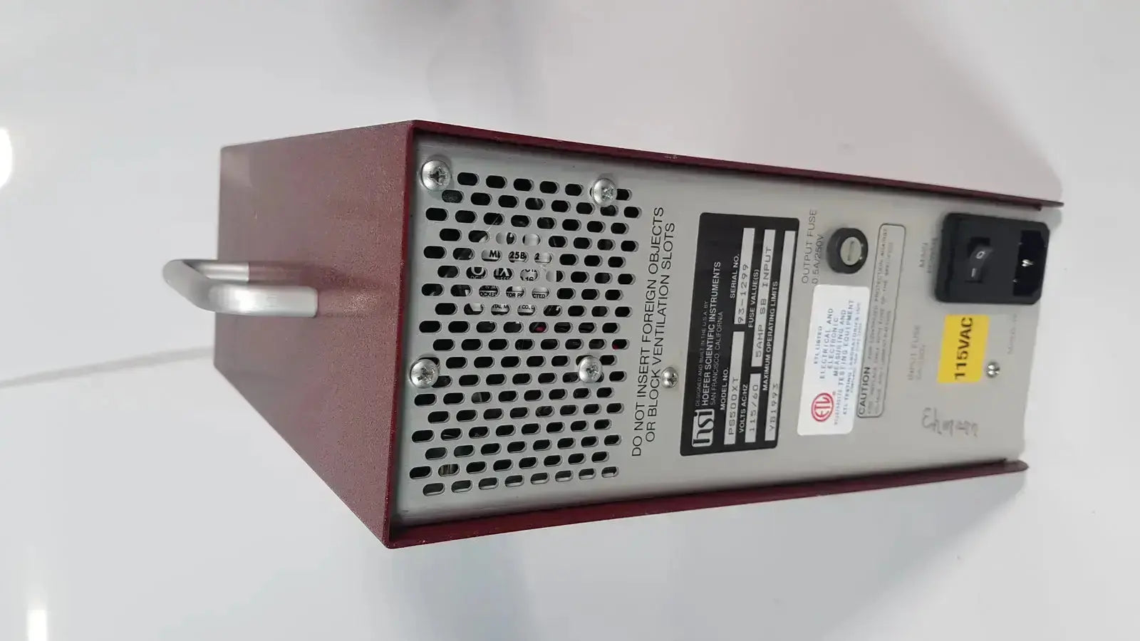 Maroon and silver metal hoefer ps500xt dc power supply with perforated ventilation panel labeled inst on its side